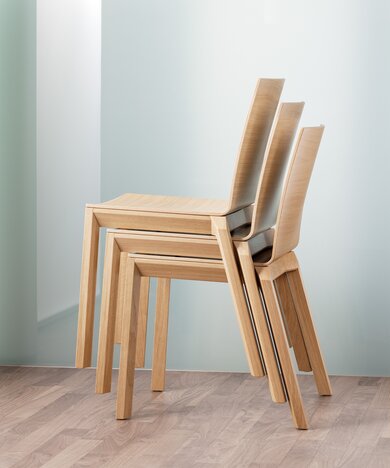 Stacked wooden chairs.