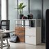 White cabinet system behind a white desk with a black swivel chair.