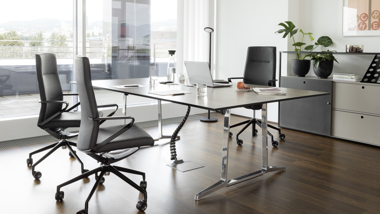 Office with three black swivel chairs.