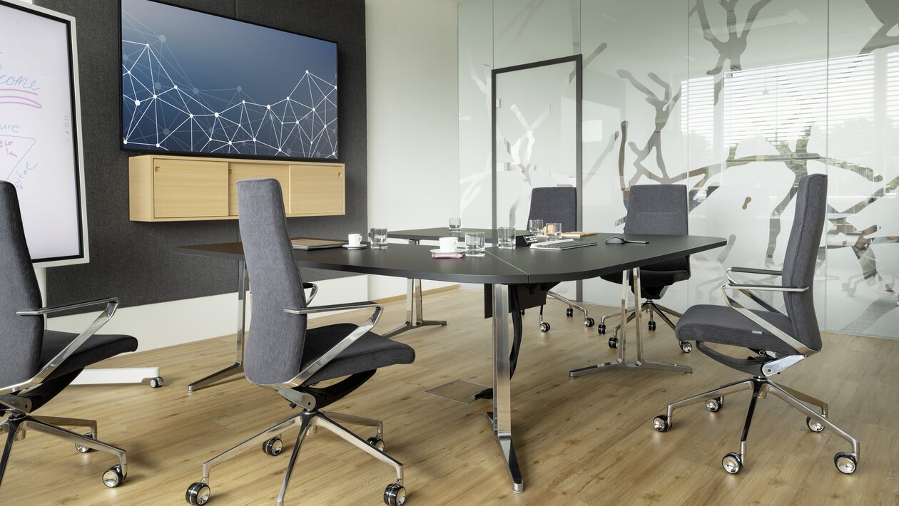 Five gray conference chairs in a meeting room.