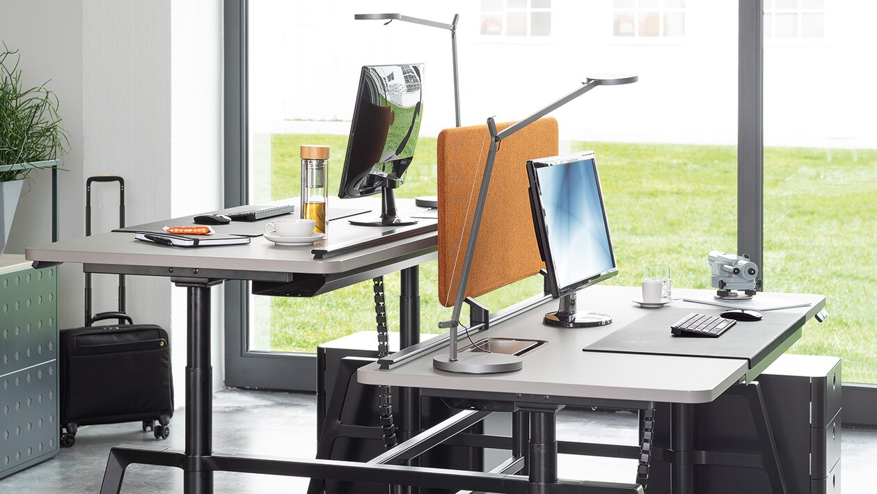 Height adjustable workstation in a modern office.