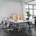 Workbench in a small office with white swivel chairs.