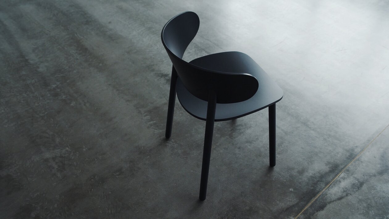 Black wooden chair photographed from above.