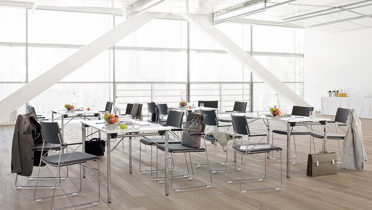 Tables and chairs with drinks and fruits.