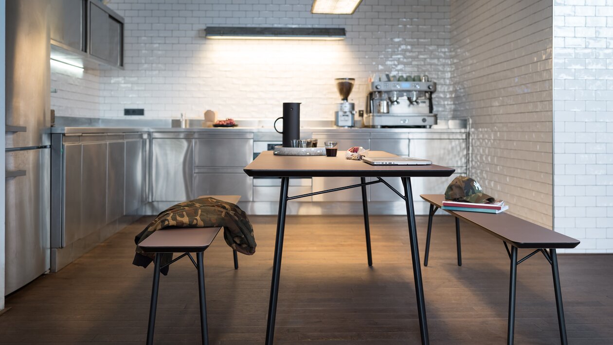 Table with two benches in a kitchen.