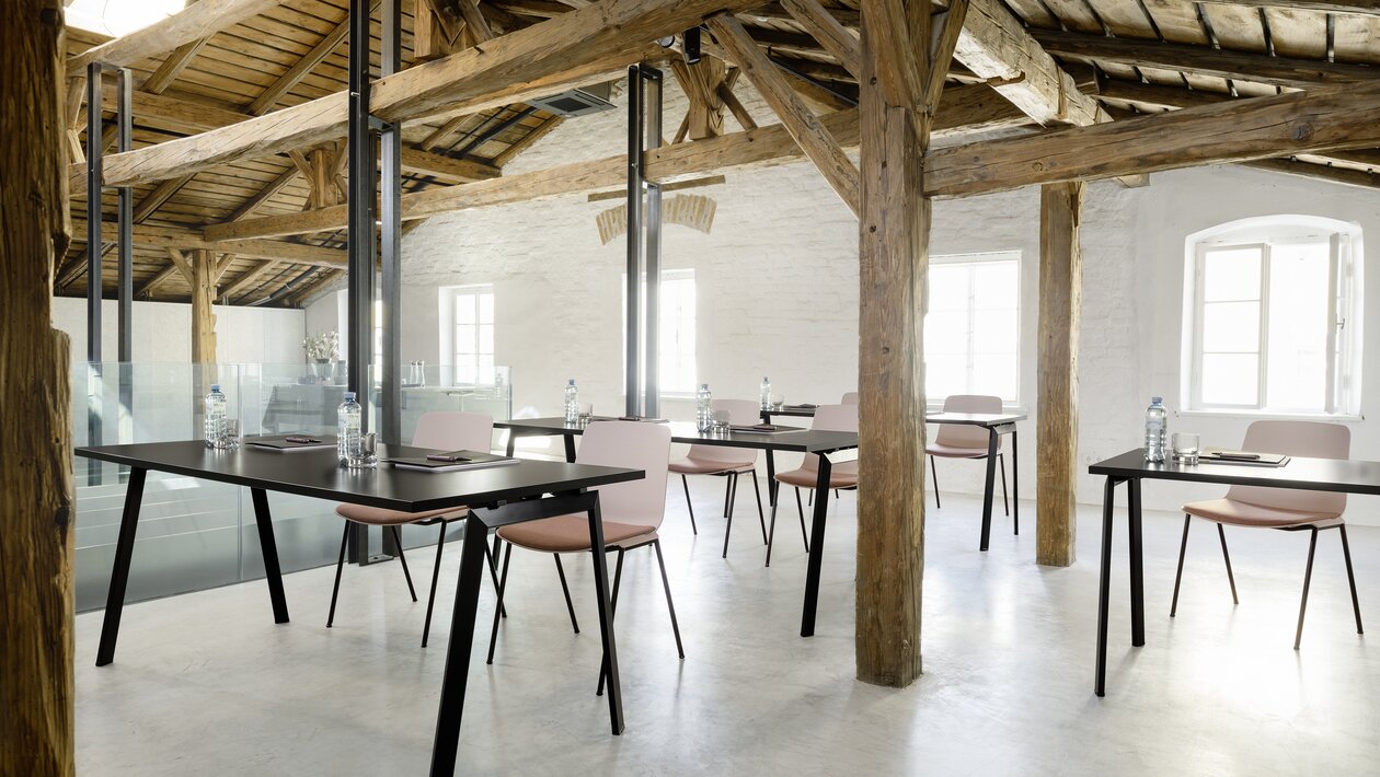 Black folding tables with rose stacking chairs.