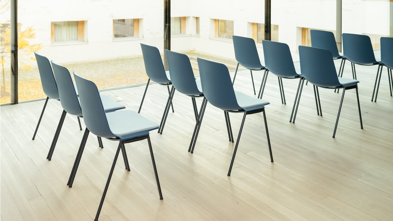 Rows of blue stacking chairs.