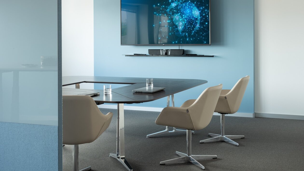 Conference table with beige conference chairs.