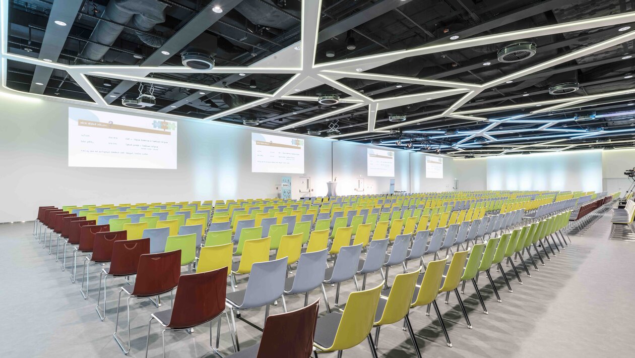 Big hall with colourful row chairs.