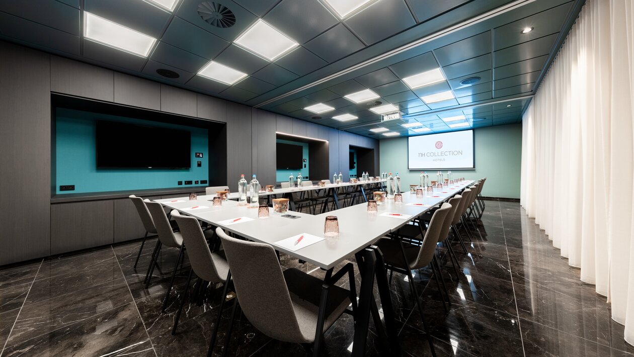 Seminar room where the tables have been organised in a U shape. 