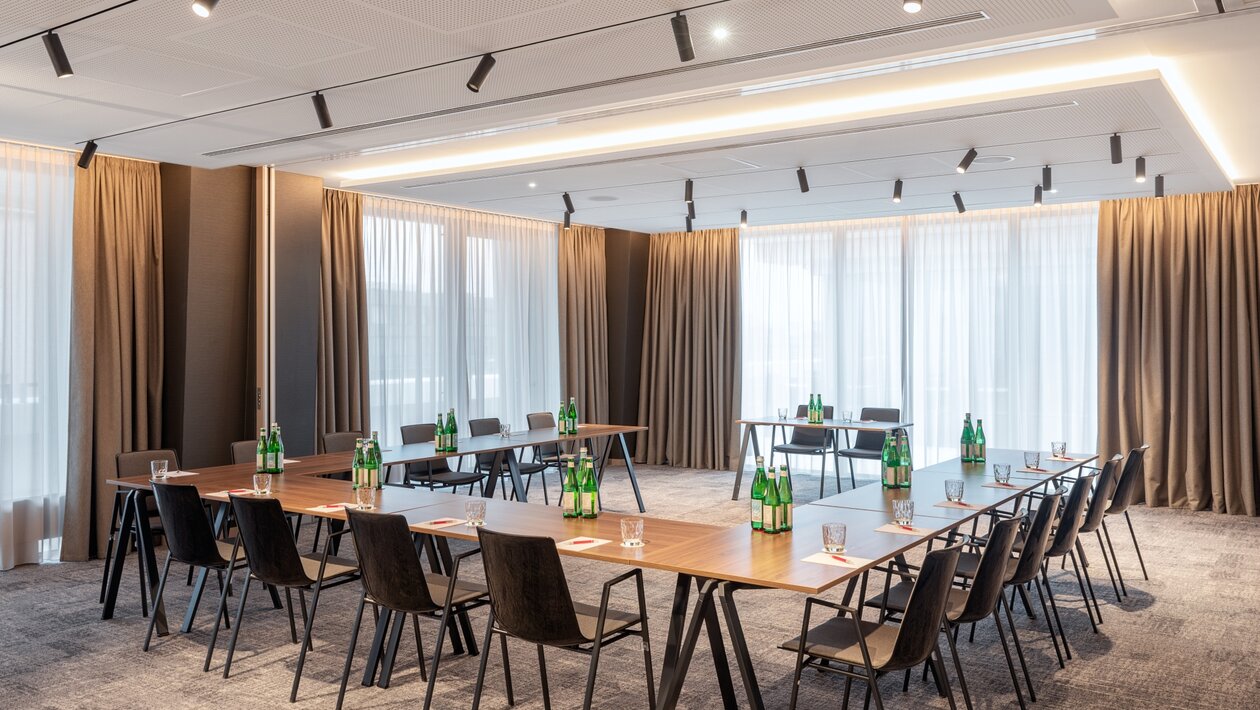 Seminar room where the tables have been organised in a U shape. 