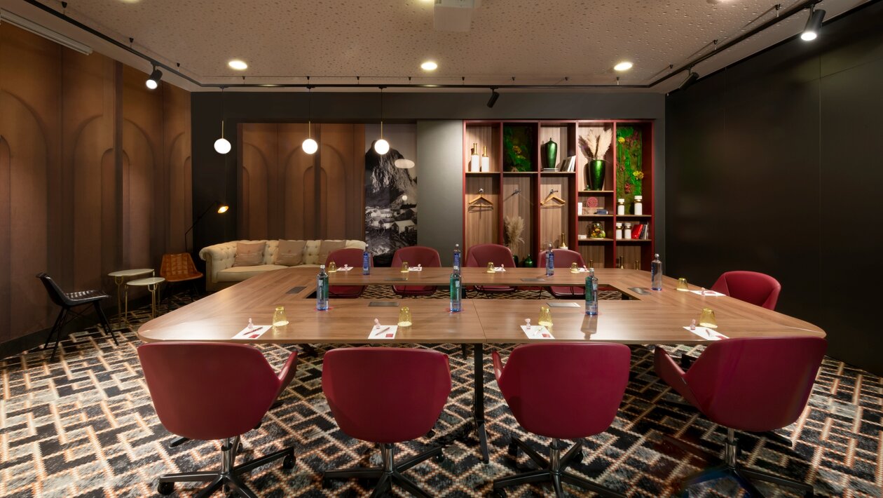 Conferece room with a nice table and red chairs.