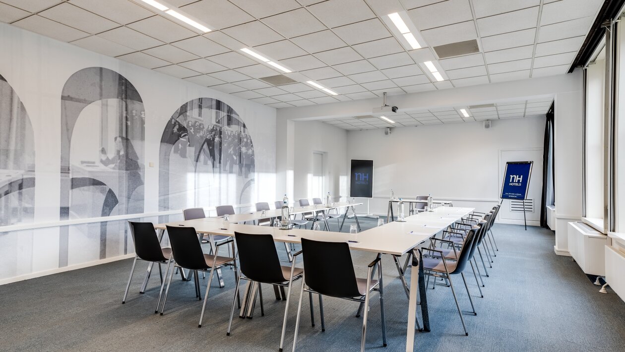 Seminar room where the tables have been organised in a U shape. 