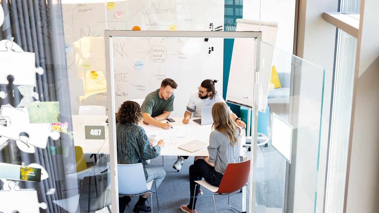 Four people in a creative room.