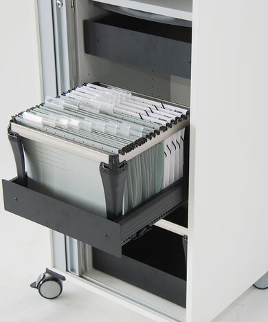 Detailed view of a trolley with hanging files. 
