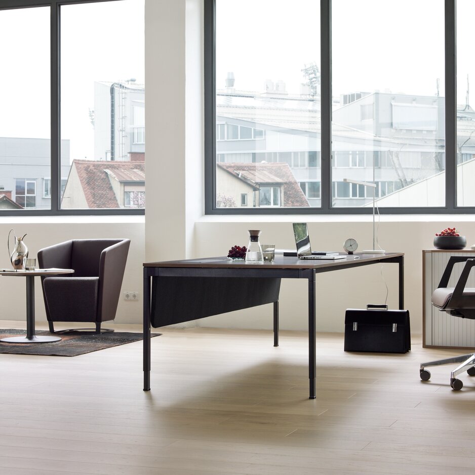 Black swivel chair at an office table.