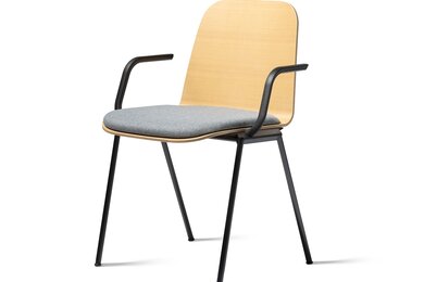 Wooden chair with armrest and gray padded seat.