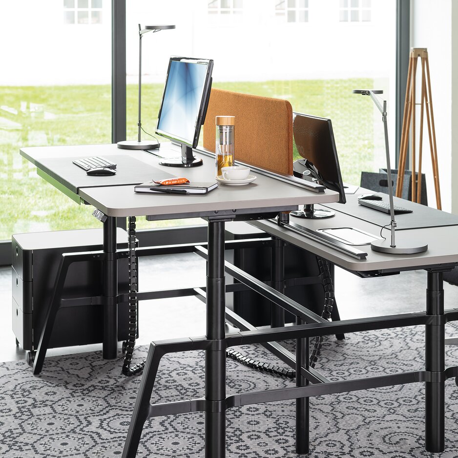 Height adjustable workstation in a modern office