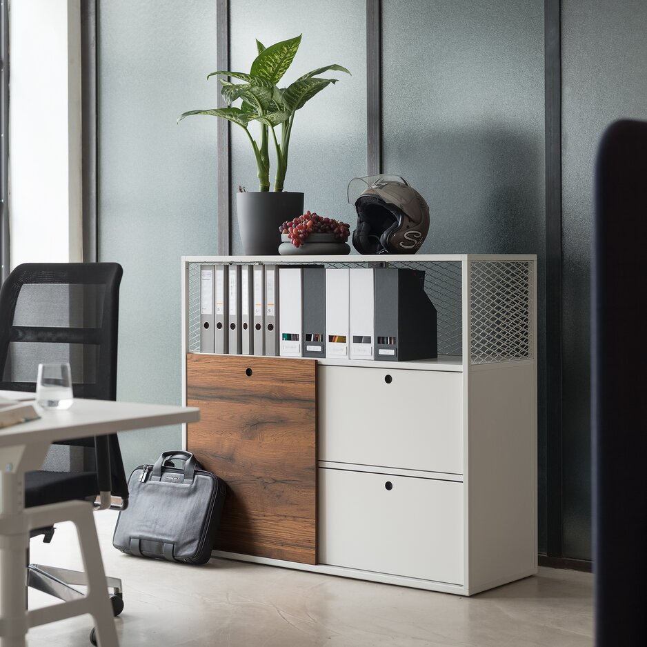 White cabinet system behind a white desk with a black swivel chair.