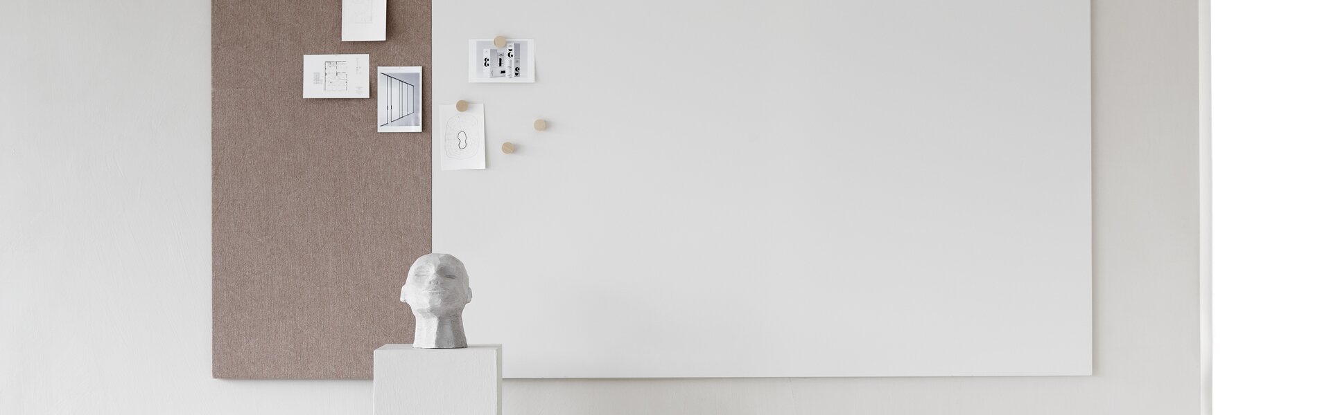 Whiteboard with a brown textile element.