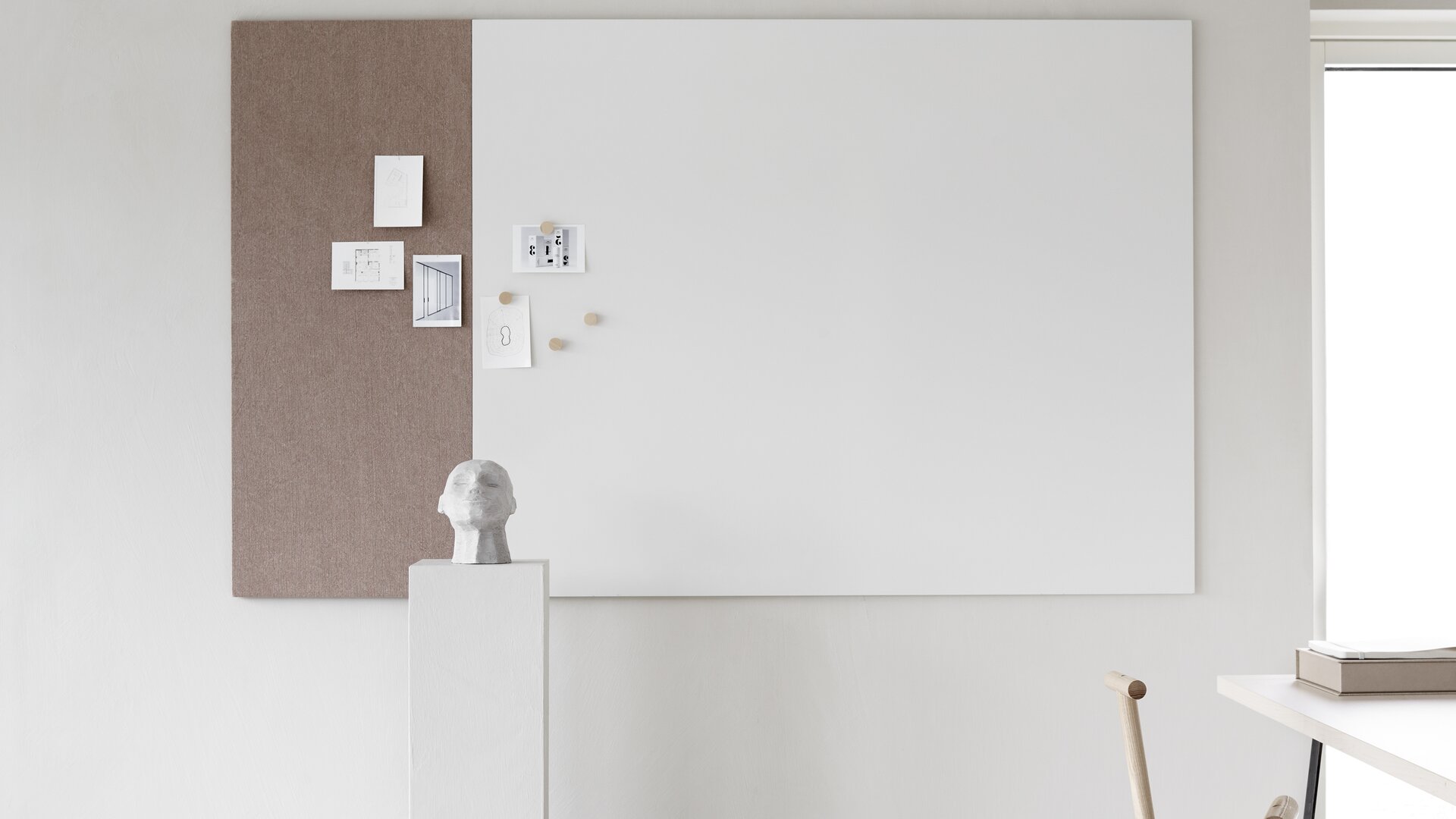 Whiteboard with a brown textile element.