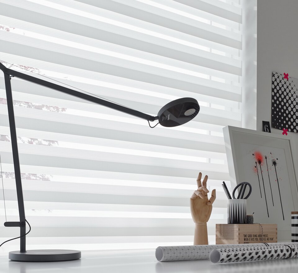 Black lamp on a desk.