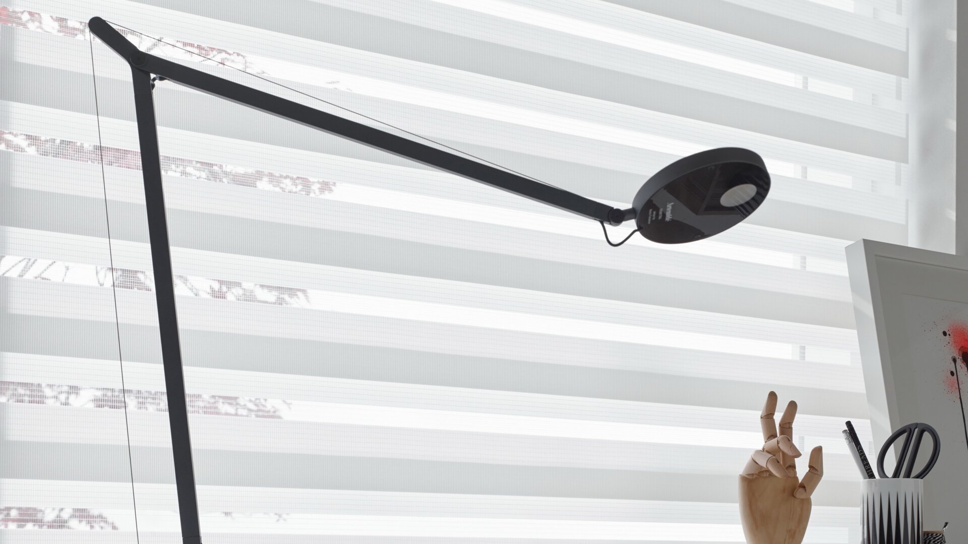Black lamp on a desk.
