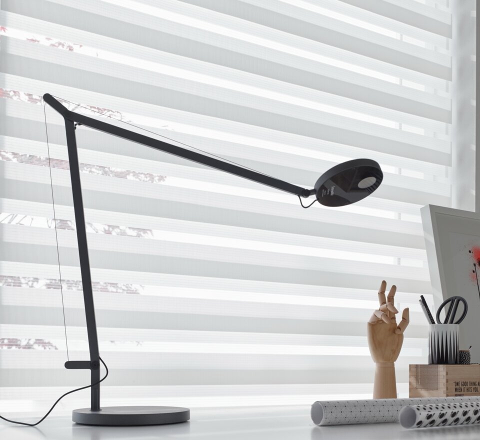 Black lamp on a desk.