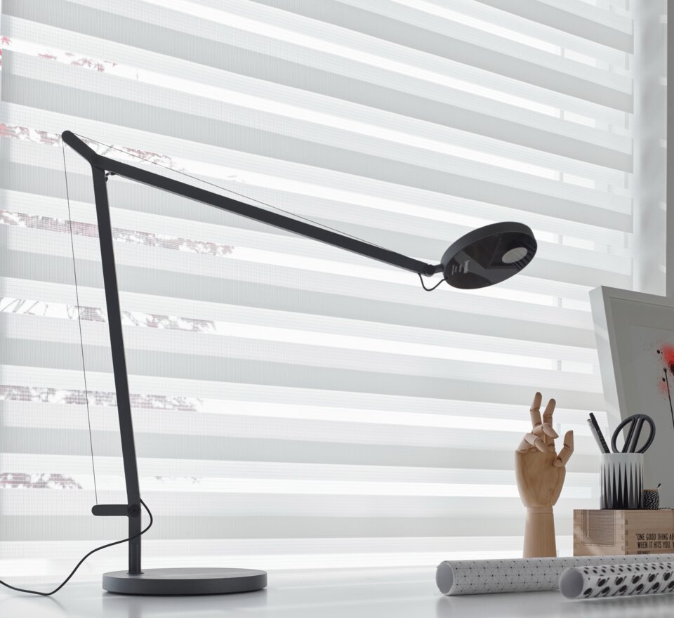 Black lamp on a desk.