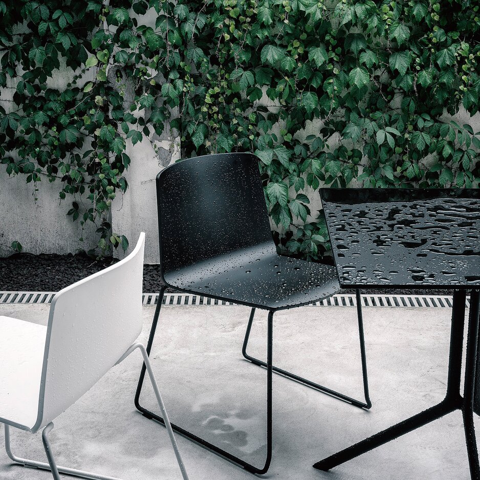 Black and white outdoor chairs on a terrace.