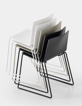 Five stacked skid base chairs.