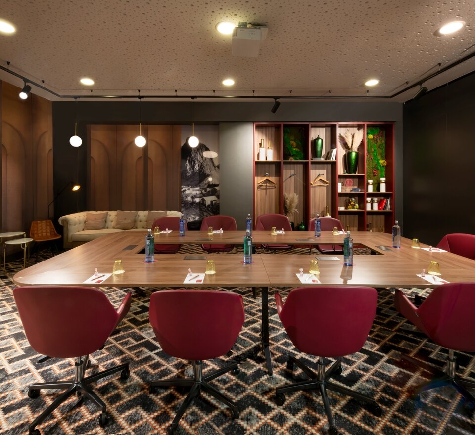 Conferece room with a nice table and red chairs.