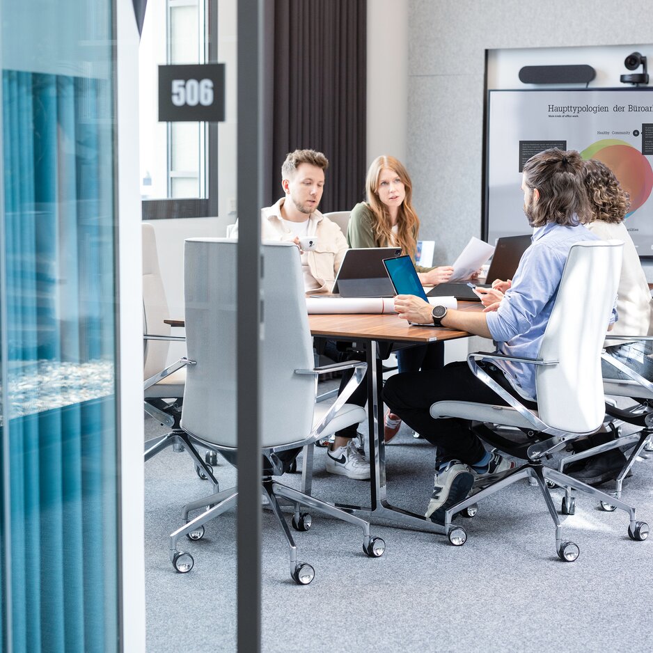 Four people in a conference room.