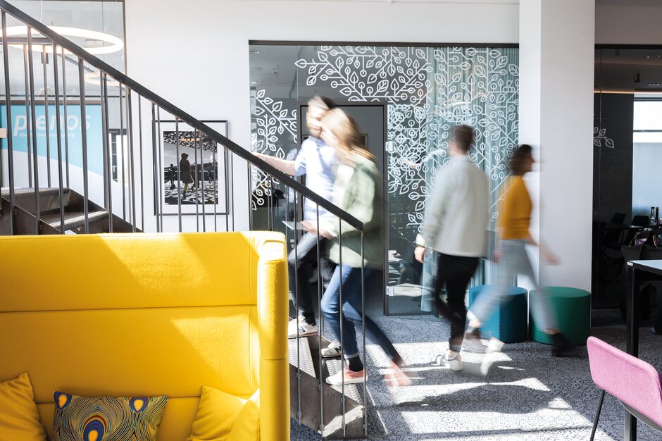 People walking around in an office.