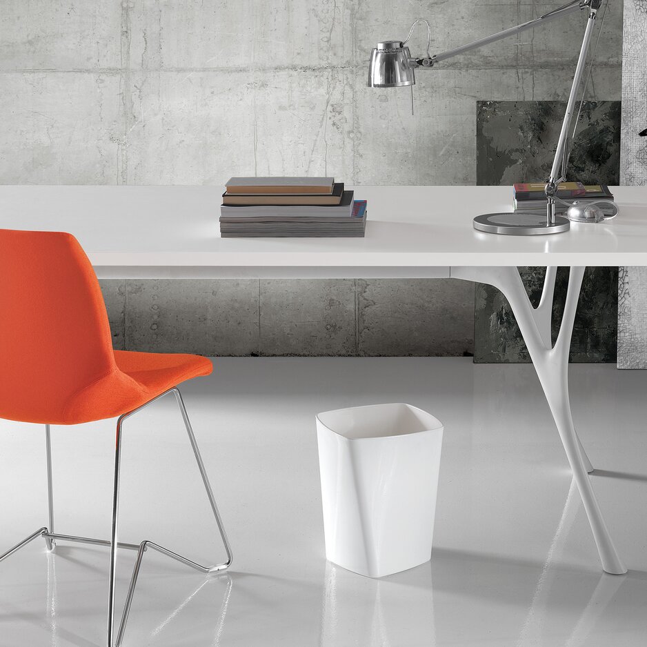 White waste paper basket in an office.