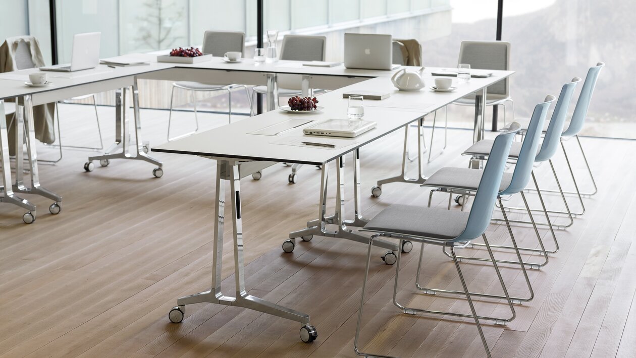 Flipflop tables with blue skid base chairs.