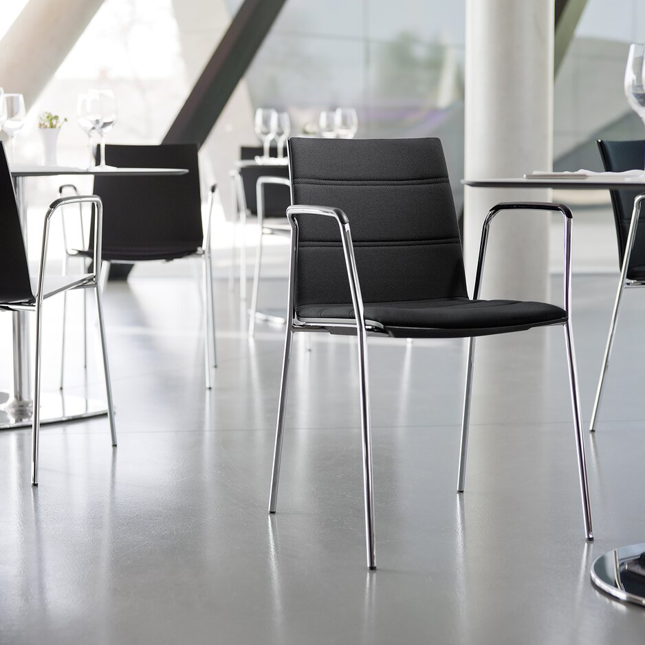 Black padded chairs with armrest.