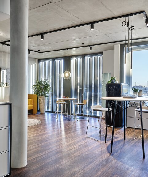 Showroom Graz Room with high tables and barstools.