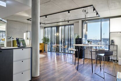 Room with high tables and barstools.