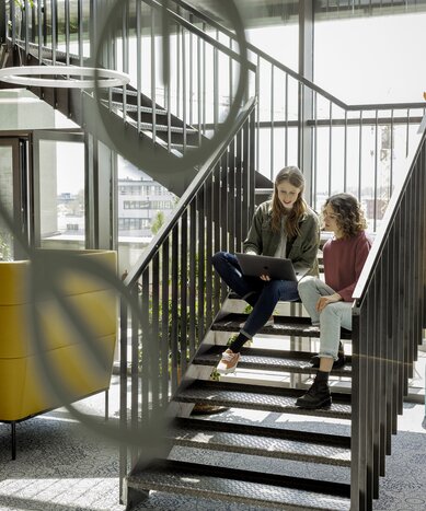 Two people working on stairs.