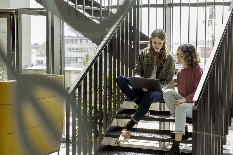 Two people working on stairs.