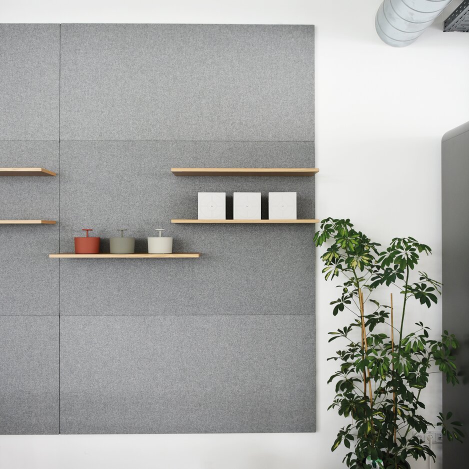 Gray wall panel with a plant.