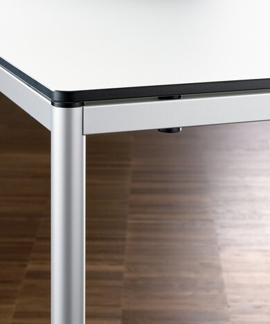 Detailed view of a table with round leg.