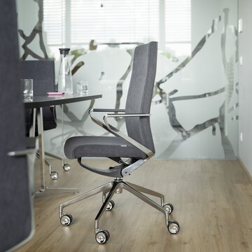 Gray conference chair with a dark table.