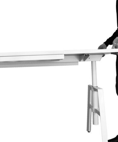 Person adjusts the height of a white desk.