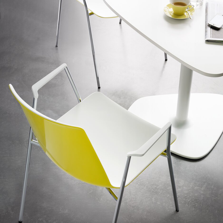 Yellow chair at a white bistro table.