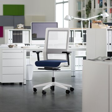 White swivel chair with blue padded seat in an office.
