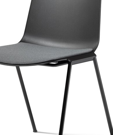 Detailed view of the upholstered seat of a black stacking chair. 