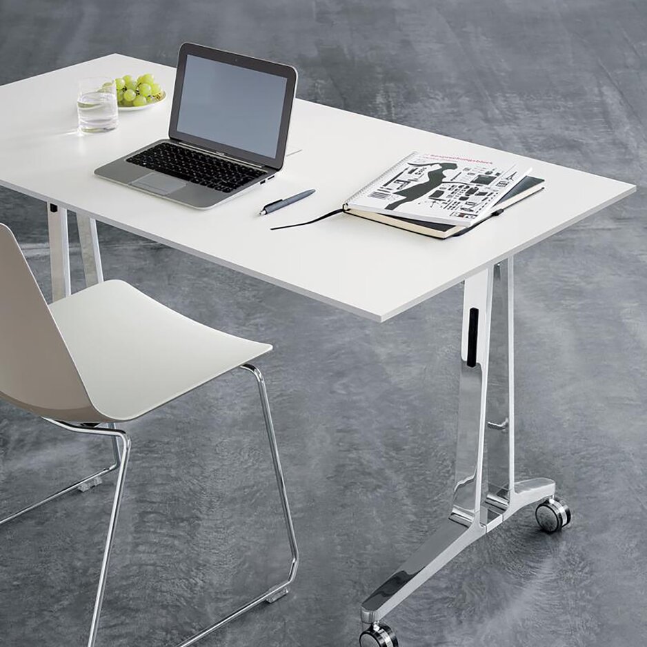 White flipflop table with a white skid base chair and a notebook. 