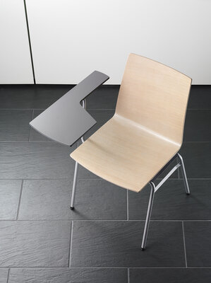 Row chair with wooden shell and writting tablet.